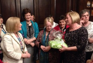 Jessica (Marlay Guild President) presents a gift of ICA books and bag made , by Craft Group to Lord Mayor Críona Ní Dhálaigh.